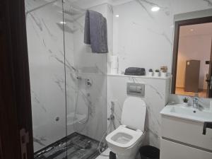 a bathroom with a shower and a toilet and a sink at Appartement de standing - Emplacement stratégique in Casablanca