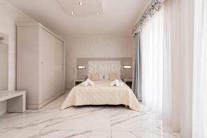 a bedroom with a bed and a large window at Riviera Luxury Rooms in Porto Cesareo