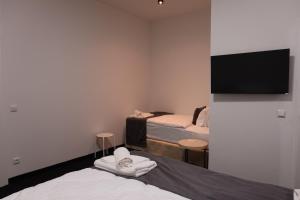 a room with two beds and a flat screen tv at nurHotel in Reinbek