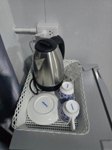 a tea pot and two cups on a table at Avatar Resort Phangan Thailand in Ban Nua