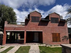 a brick house with two windows on top of it at Casa Bati in El Mollar