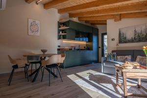 a kitchen and living room with a table and chairs at Vigne en Ville in Aosta