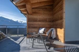 a patio with two chairs and a table on a roof at Vigne en Ville in Aosta