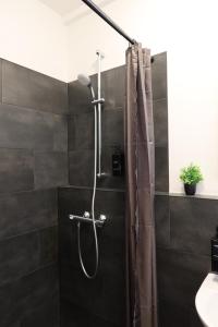a shower with a shower curtain in a bathroom at nurHotel in Reinbek +31 photos