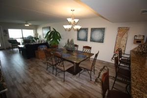 a dining room and living room with a table and chairs at 12th Floor Penthouse Beachfront, Large Balcony, Amazing Views, 3 Pools, Tennis in South Padre Island