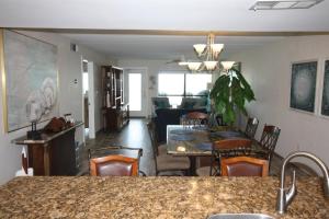 a kitchen and living room with a table and chairs at 12th Floor Penthouse Beachfront, Large Balcony, Amazing Views, 3 Pools, Tennis in South Padre Island +42 photos
