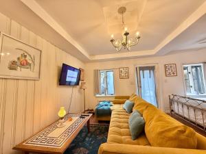 a living room with a couch and a table at Cozy Manhattan View Suite in West New York