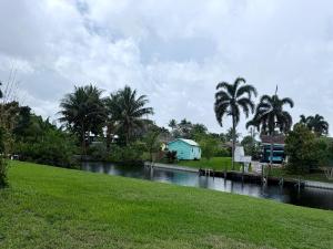 a body of water with palm trees and a house at 2 bed peaceful, lakeview studio NO FEES in Atlantis