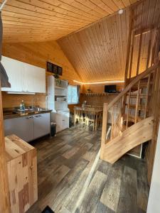 a kitchen and dining room of a log cabin at Schwedentraum in Östrahult
