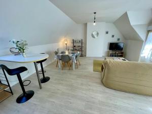 a living room with a couch and a table at Centre Treguier L escapade des quais in Tréguier