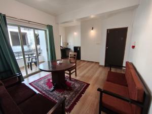 a living room with a table and a couch at Dacha by Great Host in Arambol