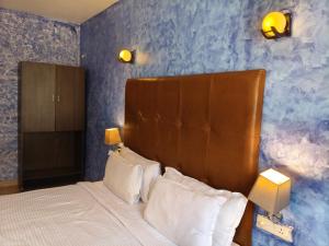 a bedroom with a bed with a blue wall at Dacha by Great Host in Arambol +57 photos
