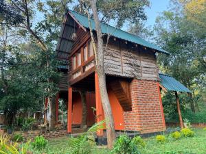 a house in the middle of a forest at Mango Tree Villa in Sigiriya