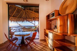 a kitchen and dining room with a table and a view of the ocean at Villa Lala Boutique Hotel Adults Only in Puerto Vallarta