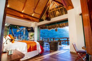 a bedroom with a bed and a large window at Villa Lala Boutique Hotel Adults Only in Puerto Vallarta +237 photos