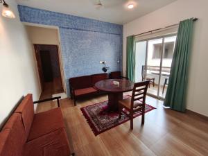 a living room with a table and a couch at Dacha by Great Host in Arambol