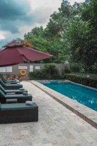 a swimming pool with lounge chairs next to a building at Radisson Hotel Guayaquil in Guayaquil