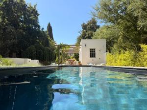 a swimming pool in front of a white house at Firemasters House Historic Church Street in Tulbagh in Tulbagh