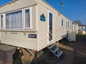 a mobile home with a sign on the side of it at Comforts caravan in Winthorpe