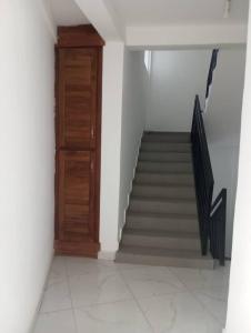 a staircase with a wooden door and a stair case at RESIDENCE Tanta in Douala