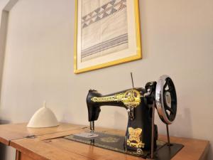 a sewing machine sitting on top of a wooden table at Luce Apartment in Shkodër
