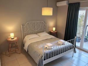 a bedroom with a bed with a metal bed frame at Luce Apartment in Shkodër