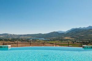 a large swimming pool with mountains in the background at Moose Ridge Hideaway Ri903 Ski Retreat Hot Tub in Eden