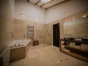 a bathroom with a tub and a sink and a mirror at Tocuyeros Boutique Hotel in Cusco +100 photos