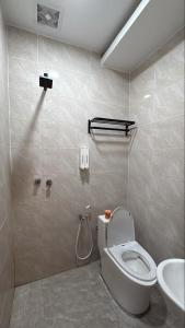 a bathroom with a toilet and a sink at LE dEON HOTEL Former Pine Hotel in Batu Gajah
