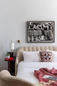 a bedroom with a bed with a black and white picture on the wall at Virgin Hotels Edinburgh in Edinburgh