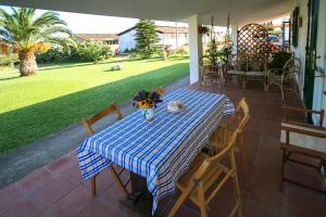 a table with a blue and white table cloth on a patio at Le Matine di San Teodoro in Stazione di Metaponto