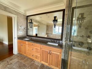 a bathroom with a sink and a shower and a mirror at Spacious Cozy House in Vancouver West in Vancouver +86 photos