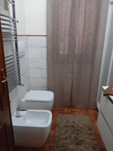 a bathroom with a toilet and a sink and a shower at Aghi&Salsedine in Anzio