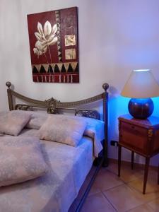 a bedroom with two beds and a table with a lamp at Aghi&Salsedine in Anzio