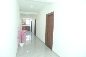 a hallway with a door and a potted plant at Hotel Akash Palace in Shāhpur