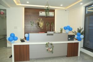 a lobby with a reception counter with blue balloons at Hotel Akash Palace in Shāhpur
