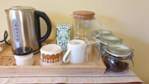 a wooden tray with cups and jars on a counter at 15 Kershaw Crescent in Luddenden Foot