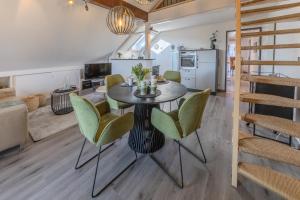 a dining room and kitchen with a table and chairs at Fewo Seesternchen in Öhningen
