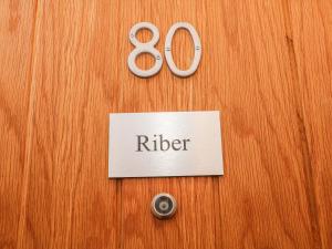 a wooden door with a sign that says refer at Riber in Matlock