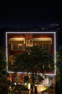 a building with lights on it at night at Saffron Inn - Near India Expo Mart in Greater Noida