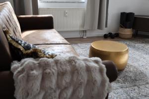 a living room with a couch and a table at Boutique Suite Hannah in Bautzen +17 photos