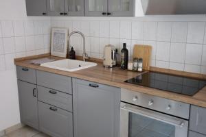 a kitchen with a sink and a counter top at Boutique Suite Hannah in Bautzen
