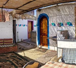 an entrance to a house with a wooden door at Sabrina home in Aswan