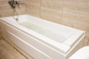 a white bath tub in a bathroom at Spring Hills Group in Dodoma