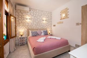 a bedroom with a bed with two towels on it at Kiki's Apartments in Barbati