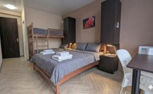 a bedroom with a bed with a ladder and a desk at TIRKIUS House in Kobuleti