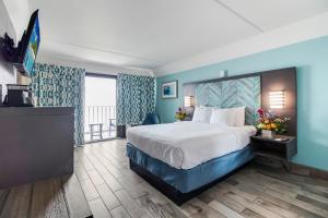 a hotel room with a bed and a large window at Crystal Coast Oceanfront Hotel in Atlantic Beach +21 photos