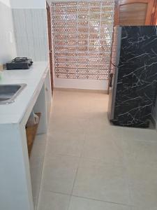 a kitchen with a sink and a refrigerator in a room at Hospedaje Mango y Mar Habitaciones in Coveñas +8 photos