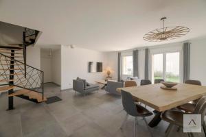 a living room with a table and chairs and a staircase at Ker Lilouane in Hirel