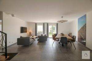a living room with a dining room table and chairs at Ker Lilouane in Hirel